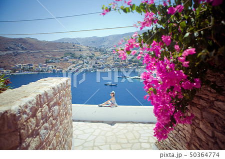 Elegant woman enjoys the view over the island Elegant woman enjoys the view over the island 50364774