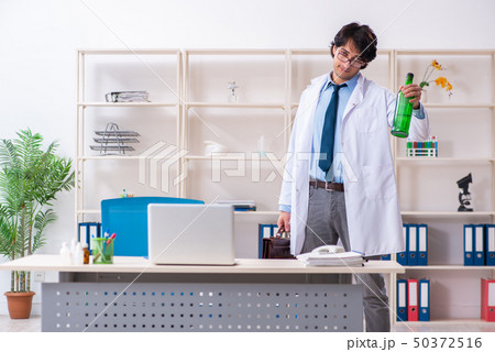 Young male doctor drinking in the office Young male doctor drinking in the office 50372516