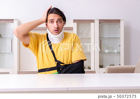 Young man after car accident suffering at home  50372575
