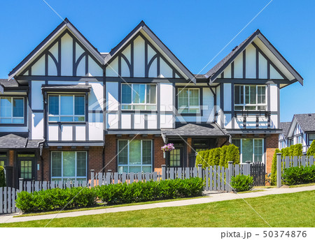 Row of new townhouses on bright sunny day. Row of new townhouses on bright sunny day. 50374876