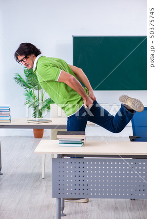 Male student suffering from urge in the classroom Male student suffering from urge in the classroom 50375745