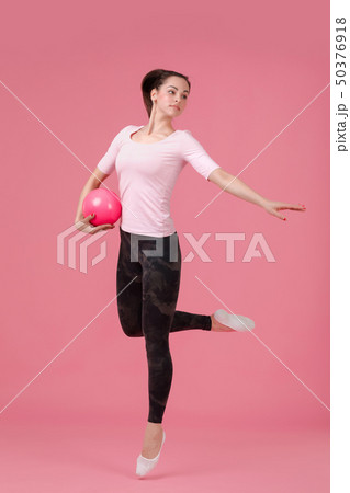 smiling woman jumping with the ball 50376918