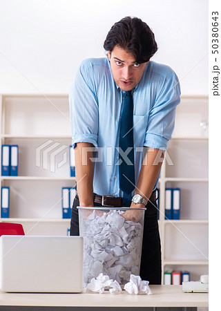Businessman rejecting new ideas with lots of papers 50380643