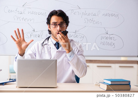 Young male doctor neurologist in front of whiteboard  50380827