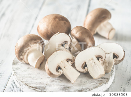 Champignon mushrooms on the wooden board 50383503