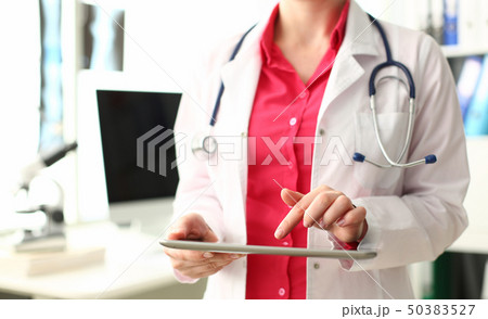 Woman Doctor with Stethoscope Hold Computer Tablet Woman Doctor with Stethoscope Hold Computer Tablet 50383527