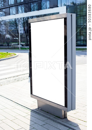 Vertical small billboard in the city on the sidewalk. Mock up for advertising or announcements 50383680
