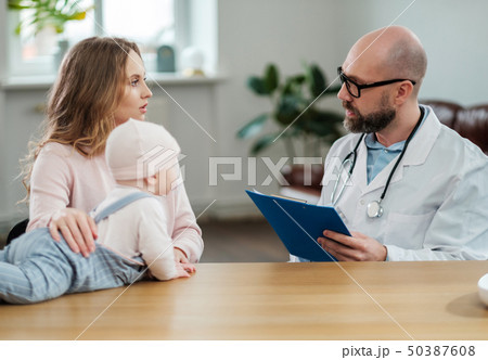 Mother with baby visiting pediatrician Mother with baby visiting pediatrician 50387608