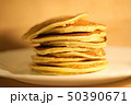 Tasty pancakes on white plate, wood background 50390671