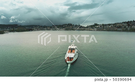 Aerial view of a ship with waving Swiss flag heading for Lucerne on the lake, Switzerland 50390694