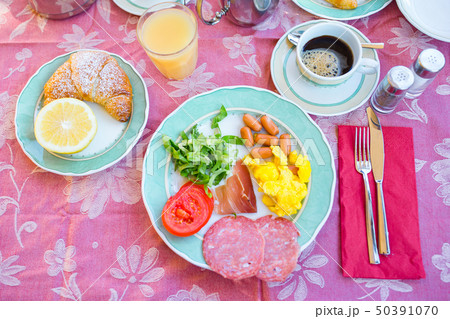 Tasty traditional appetizing yummy breakfast at the restaraunt outdoors. Fresh coffee and croissant 50391070