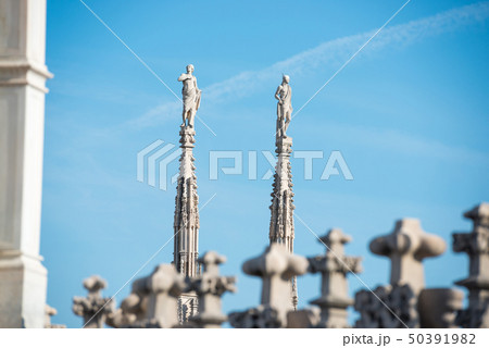 Marble statues - architecture on top of roof Duomo Marble statues - architecture on top of roof Duomo 50391982