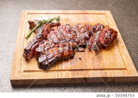 food, delicious, horse meat and craft concept - serving of grilled steak food, delicious, horse meat and craft concept - serving of grilled steak 50398703
