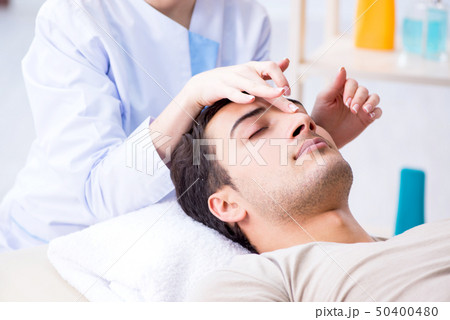 Young handsome man visiting female doctor cosmetologist 50400480