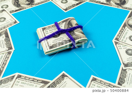 Dollar bills folded in half on light blue Dollar bills folded in half on light blue 50400884
