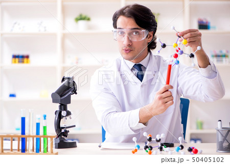 Young male scientist working in the lab  50405102