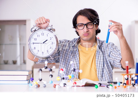 Young student physicist preparing for exam at home Young student physicist preparing for exam at home 50405173