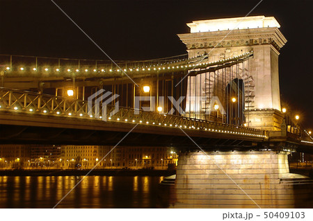 chain bridge illuminated by street lamps colorful 50409103