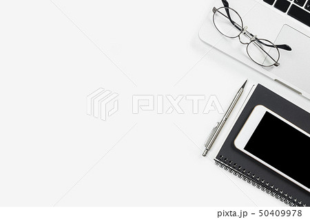 White office desk table with laptop and supplies White office desk table with laptop and supplies 50409978
