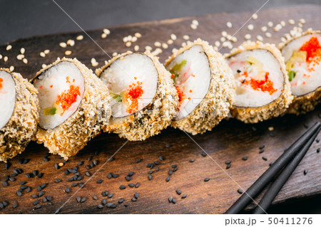 Tempura maki sushi roll on wooden platter Tempura maki sushi roll on wooden platter 50411276