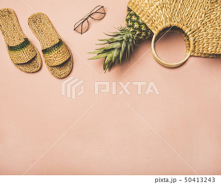 Summer apparel items and fresh pinapple over pink Summer apparel items and fresh pinapple over pink 50413243