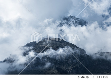 Majestical mountains in clouds in overcast evening Majestical mountains in clouds in overcast evening 50414190