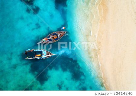 Aerial view of the fishing boats in clear blue sea 50414240