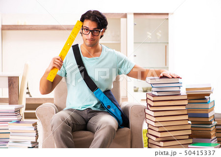 Male student with many books at home  50415337