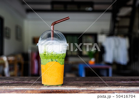 Ice Matcha Green Tea In Plastic Cup With Straw On Wooden Desk Stock Photo,  Picture and Royalty Free Image. Image 63010707.