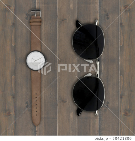 sunglasses and wristwatch on wooden background 50421806