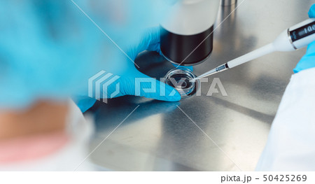 Woman scientist working with pipette in laboratory 50425269