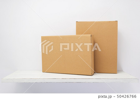 cardboard box on wooden shelf 50426766