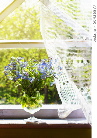 Bouquet of the forget-me-nots in the wineglass 50426877
