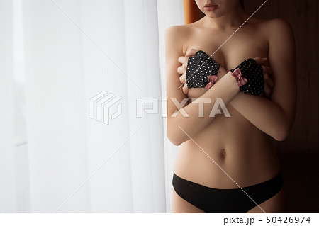 Young sensual naked woman posing in dark room 50426974