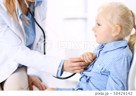 Doctor and a little blonde girl. Usual health exam. Medicine and healthcare concept 50429142