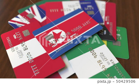 Many credit cards with different flags, emphasized bank card with flag of North Korea. 3D rendering 50429506