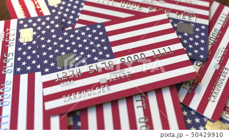 Pile of credit cards with flag of the United States. American banking system conceptual 3D rendering 50429910