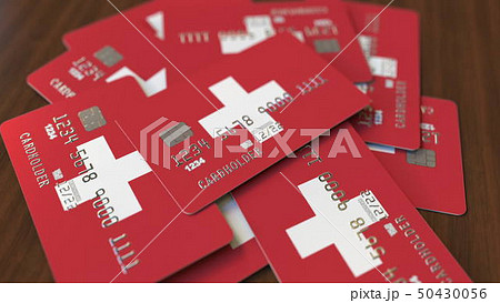 Pile of credit cards with flag of Switzerland. Swiss banking system conceptual 3D rendering 50430056