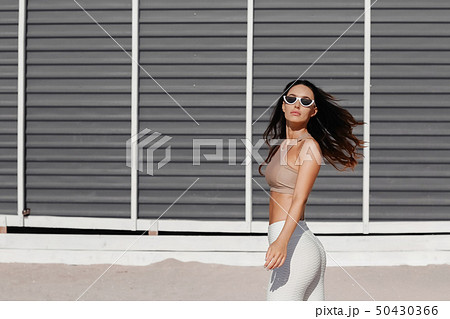 Fitness sport girl in fashion sportswear doing yoga fitness exercise in the street, outdoor sports 50430366