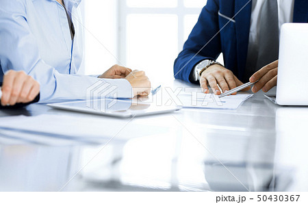 Group of business people and lawyers discussing contract papers sitting at the table, close-up 50430367