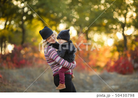 happy family mother father and baby on autumn walk in the park 50430798