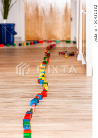 Track of dominoes on a wooden floor home Track of dominoes on a wooden floor home 50431182