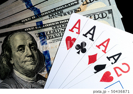 Four aces Playing Cards and Stack of 100 American Dollars Bills. 50436871