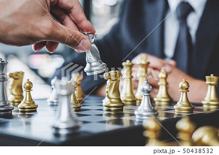 Two businessman playing chess game to plan Two businessman playing chess game to plan 50438532
