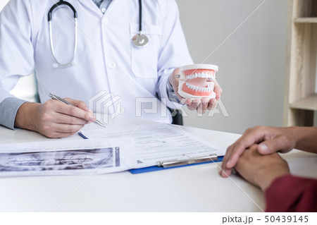 Male doctor or dentist writing report working with Male doctor or dentist writing report working with 50439145