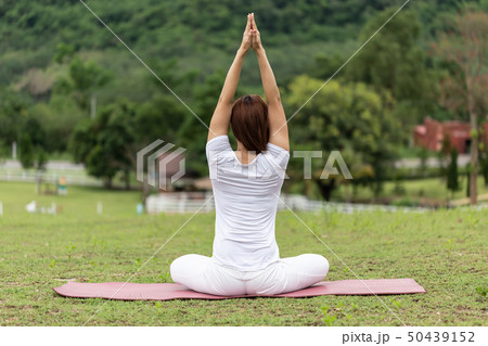 woman sitting on yoga mat practice lotus pose  50439152