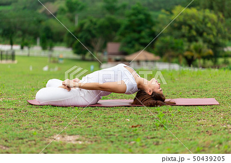 woman sitting on yoga mat practice Supta Virasana 50439205