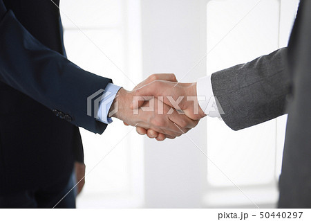 Business people shaking hands at meeting or negotiation in modern office, close-up. Teamwork Business people shaking hands at meeting or negotiation in modern office, close-up. Teamwork 50440297