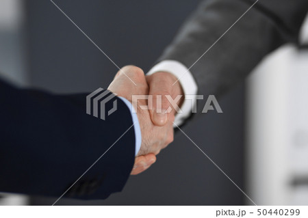 Business people shaking hands at meeting or negotiation in modern office, close-up. Teamwork Business people shaking hands at meeting or negotiation in modern office, close-up. Teamwork 50440299