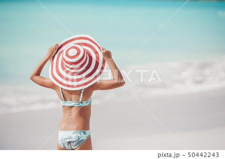 Cute little girl in hat at beach during caribbean vacation Cute little girl in hat at beach during caribbean vacation 50442243